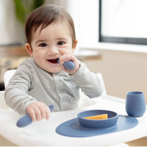 What feeding and swallowing milestones start at 6 months of age?