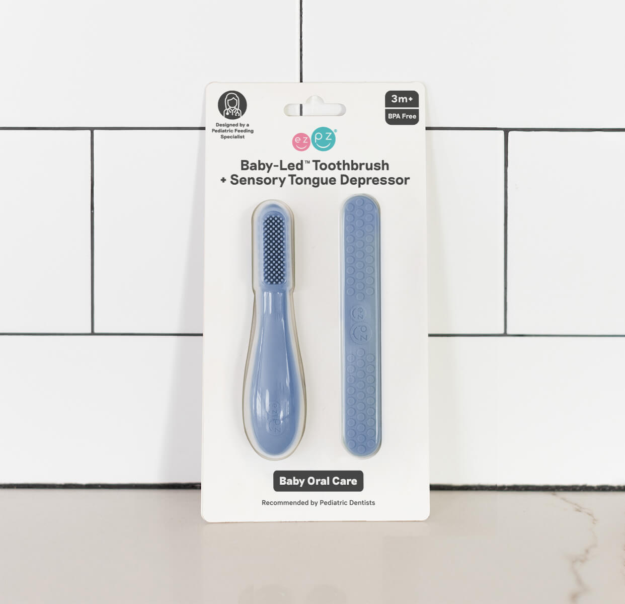 ezpz baby led toothbrush and sensory tongue depressor in indigo blue