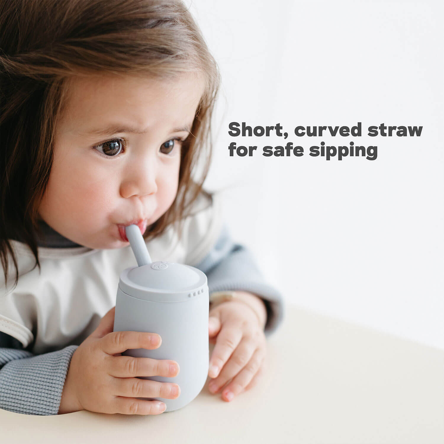 Mini Cup + Straw Training System by ezpz has a short, curved straw for safe sipping
