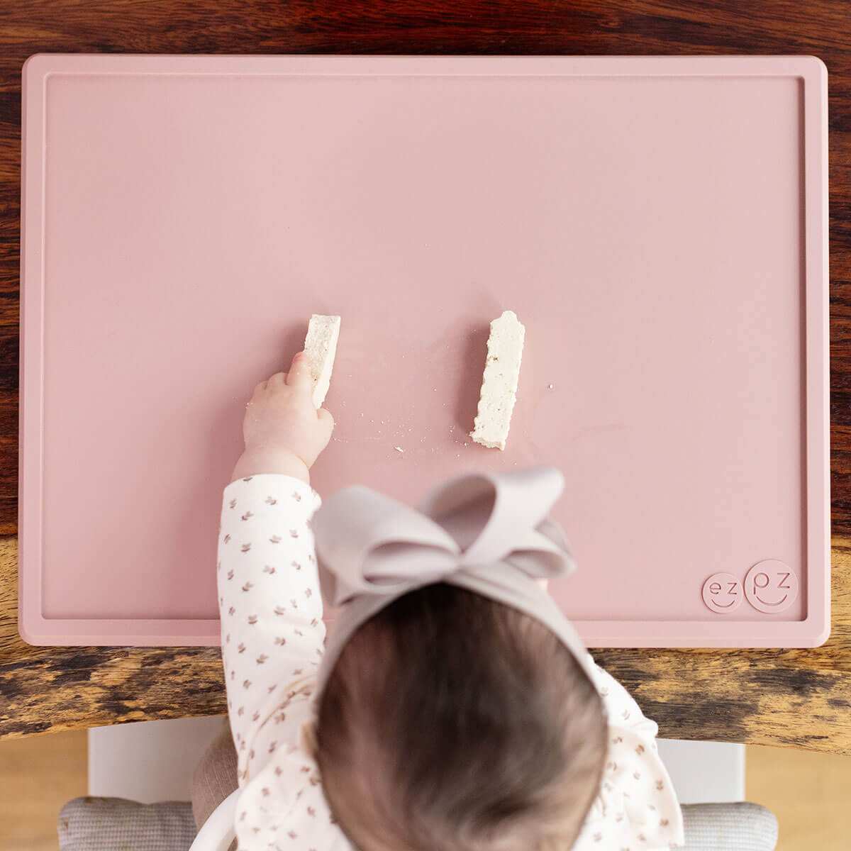 ezpz Mini Placemat in Blush Pink is a silicone placemat for toddlers that grips to the table