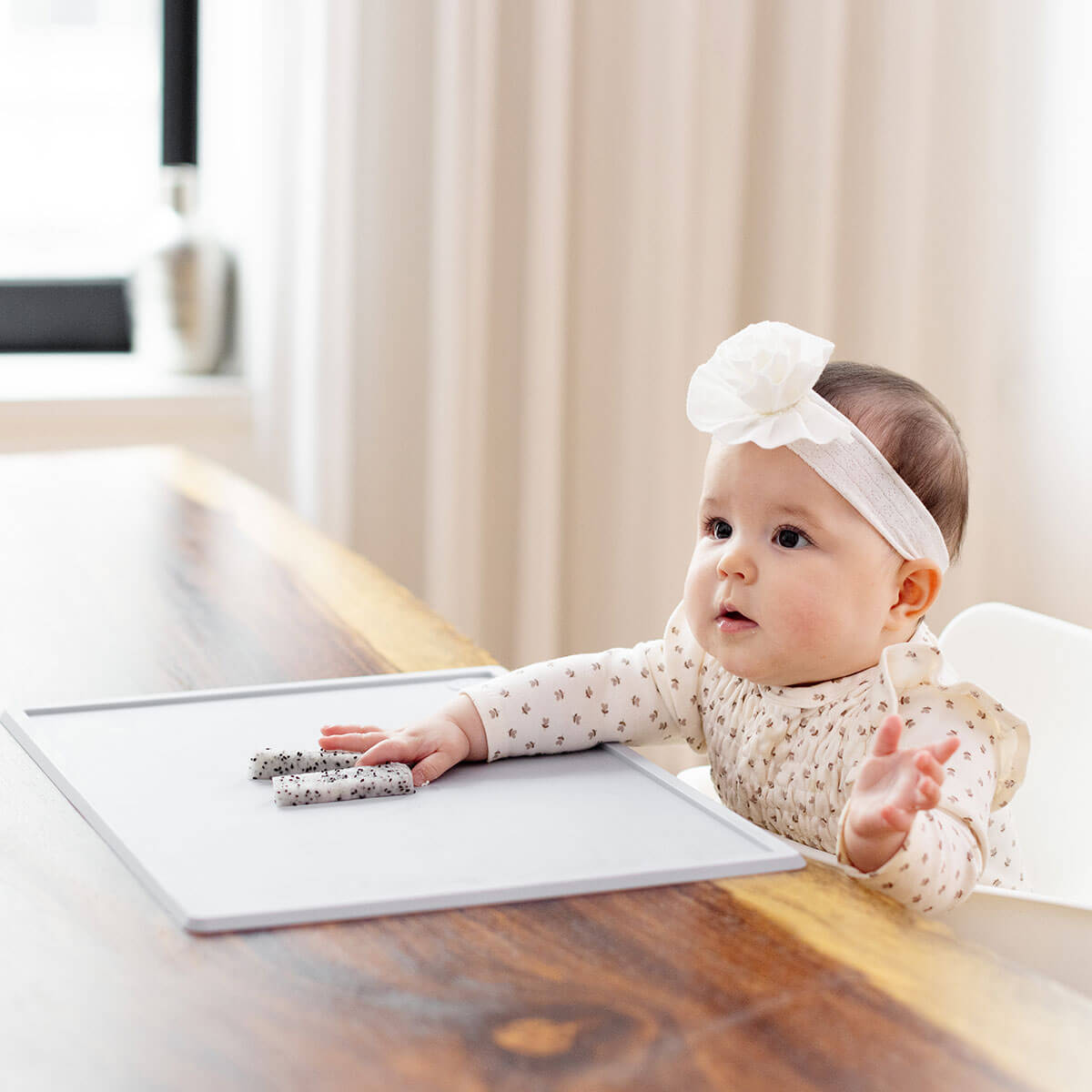 ezpz Mini Placemat in Pewter Gray is a silicone placemat for toddlers that grips to the table