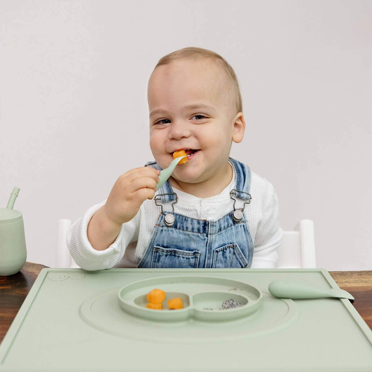 ezpz Mini Placemat in Sage Green is a silicone placemat for toddlers that grips to the table