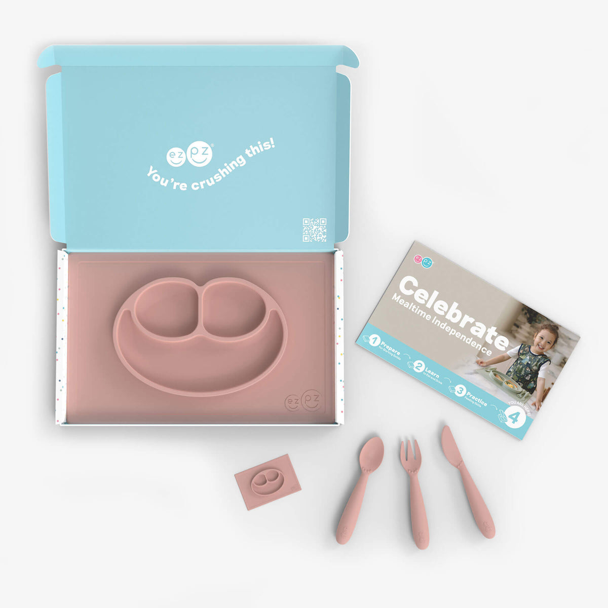 ezpz Kit 4 - Celebrate Mealtime Independence in Blush Pink includes the Happy Mat, Happy Utensils, and Micro Mat