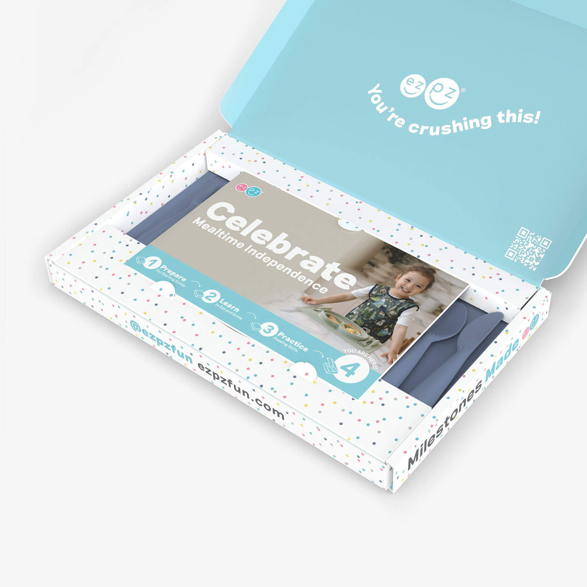 ezpz Kit 4 - Celebrate Mealtime Independence in Indigo Blue includes the Happy Mat, Happy Utensils, and Micro Mat