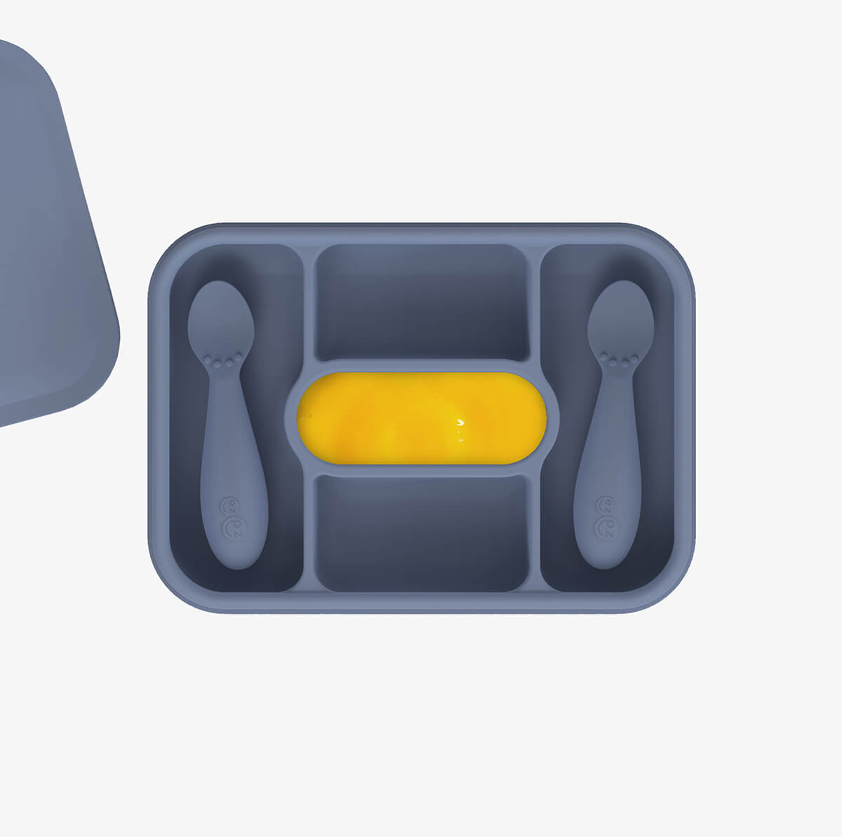 ezpz travel box in indigo blue is an all-in-one feeding + storage system that helps families pack, transport, and serve baby’s meals when away from home