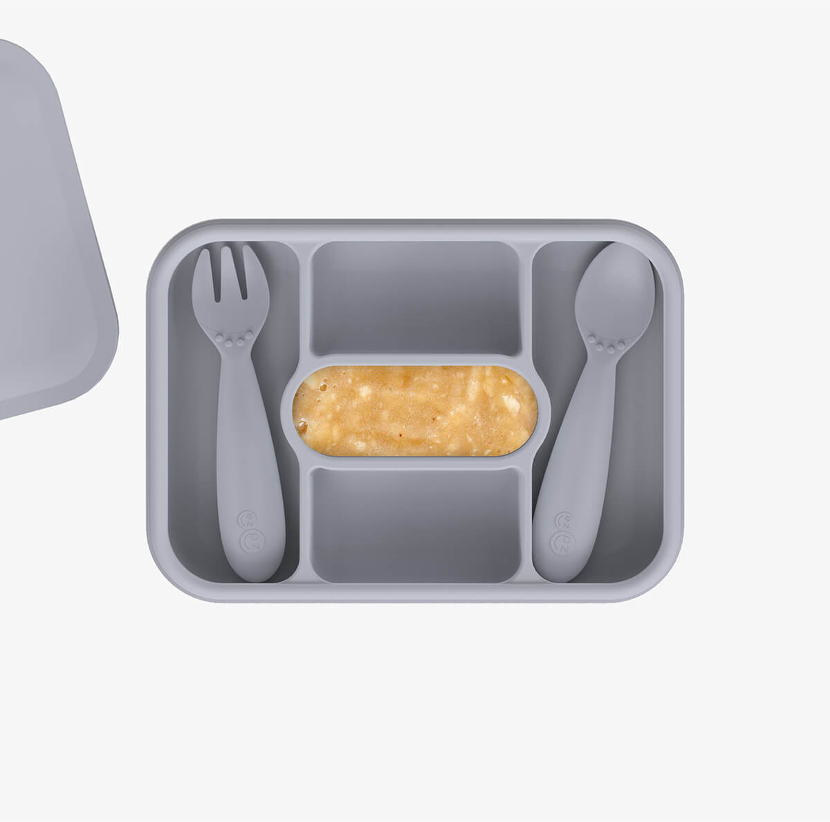ezpz travel box in pewter gray is an all-in-one feeding + storage system that helps families pack, transport, and serve baby’s meals when away from home