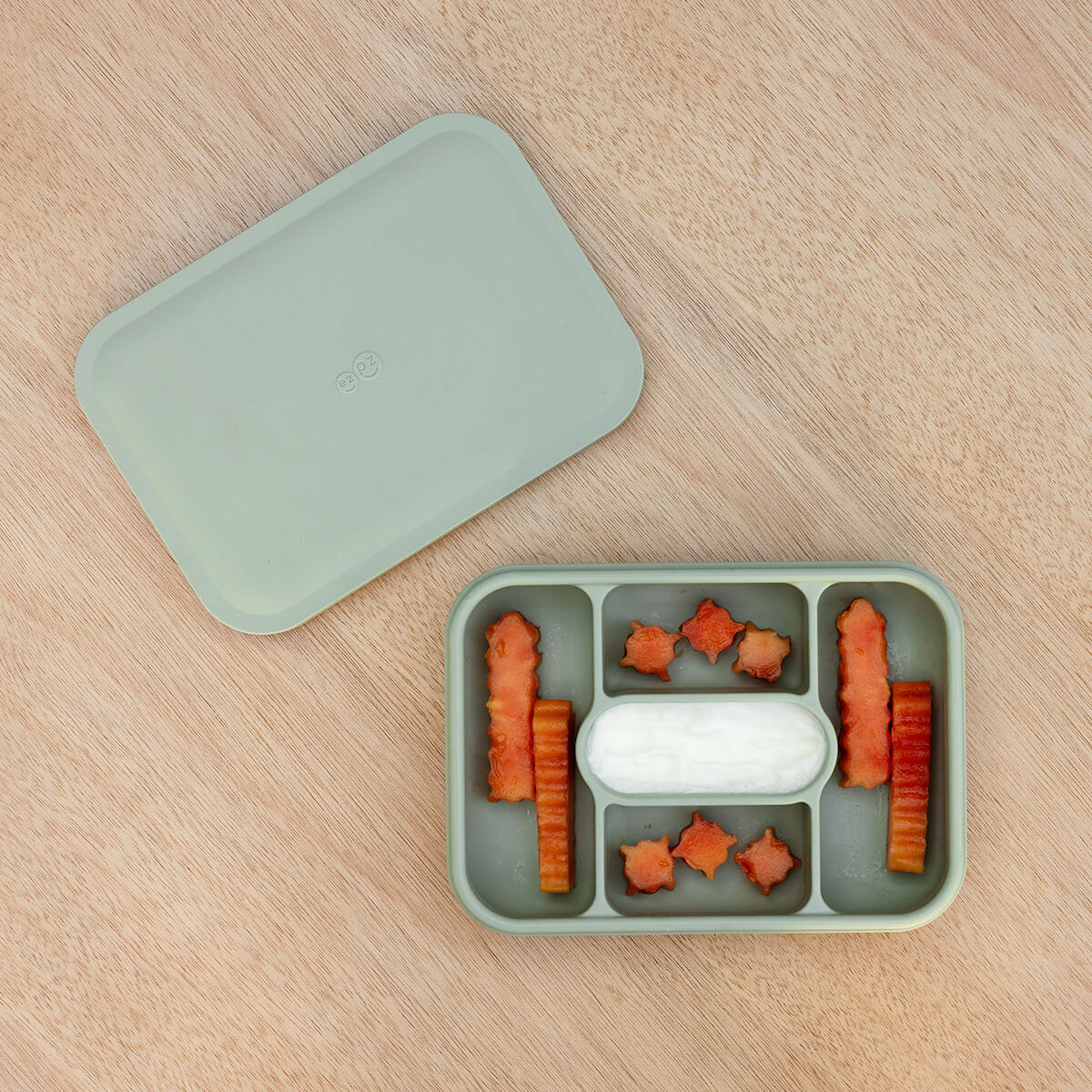 ezpz travel box in sage green is an all-in-one feeding + storage system that helps families pack, transport, and serve baby’s meals when away from home