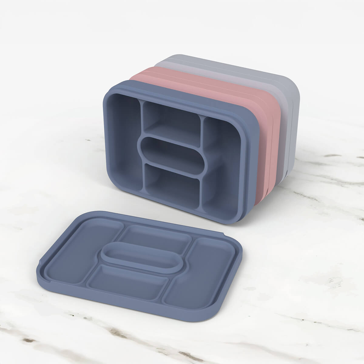 ezpz travel box in indigo blue is an all-in-one feeding + storage system that helps families pack, transport, and serve baby’s meals when away from home