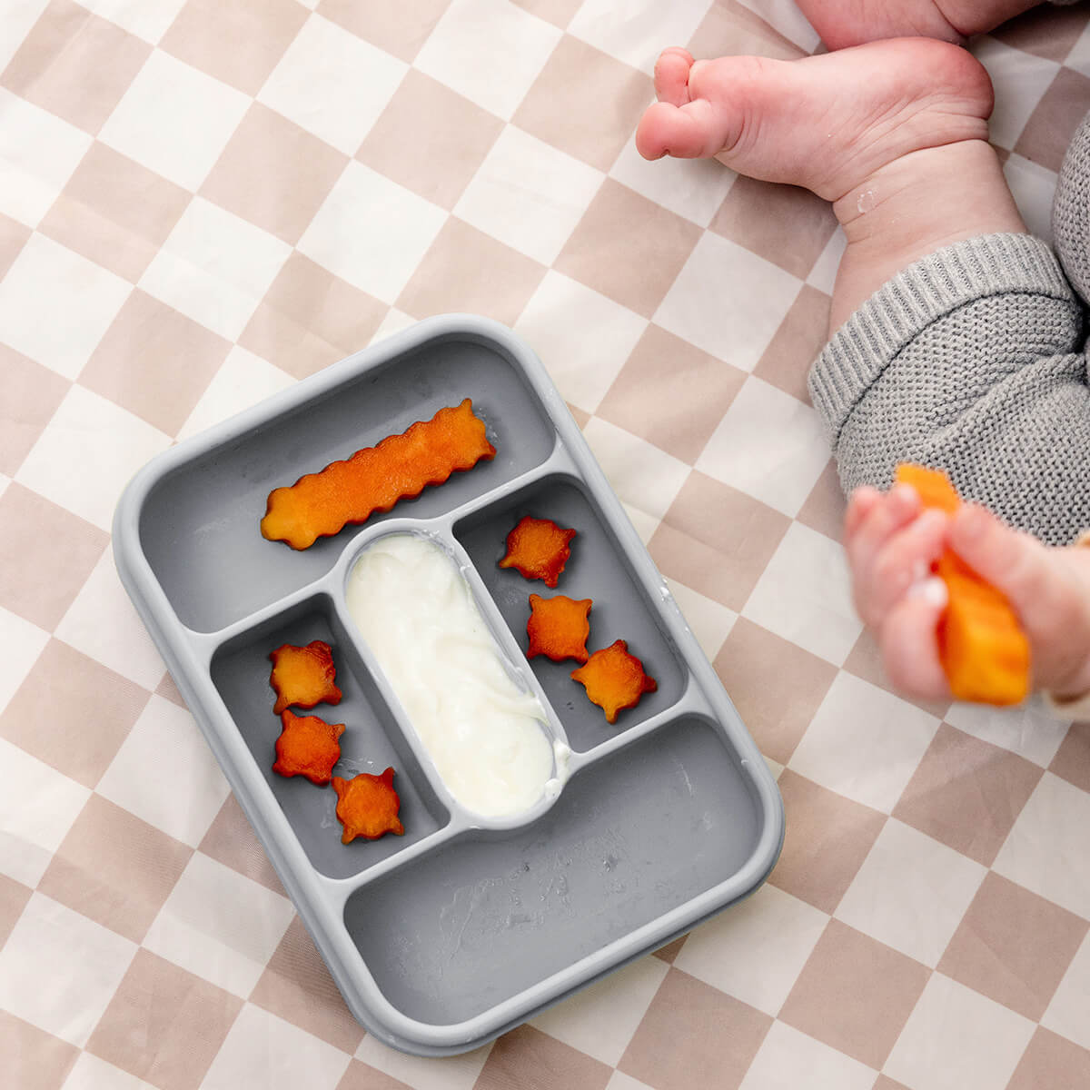 ezpz travel box in pewter gray is an all-in-one feeding + storage system that helps families pack, transport, and serve baby’s meals when away from home