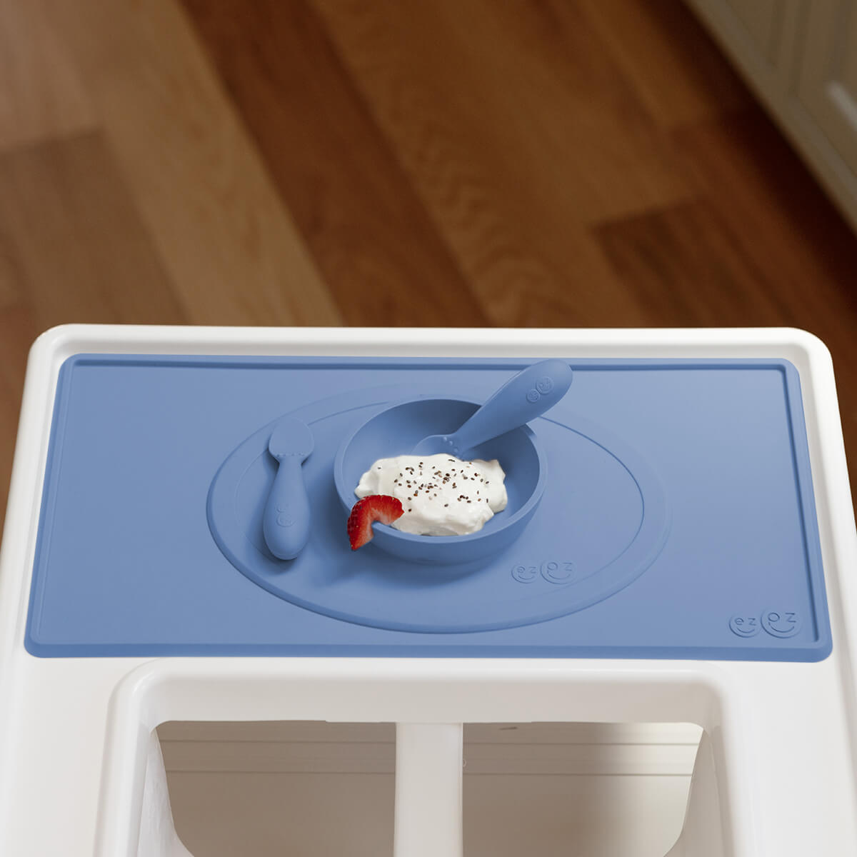 The Tiny Placemat in Indigo is a non-slip, silicone placemat that fits on most highchair trays