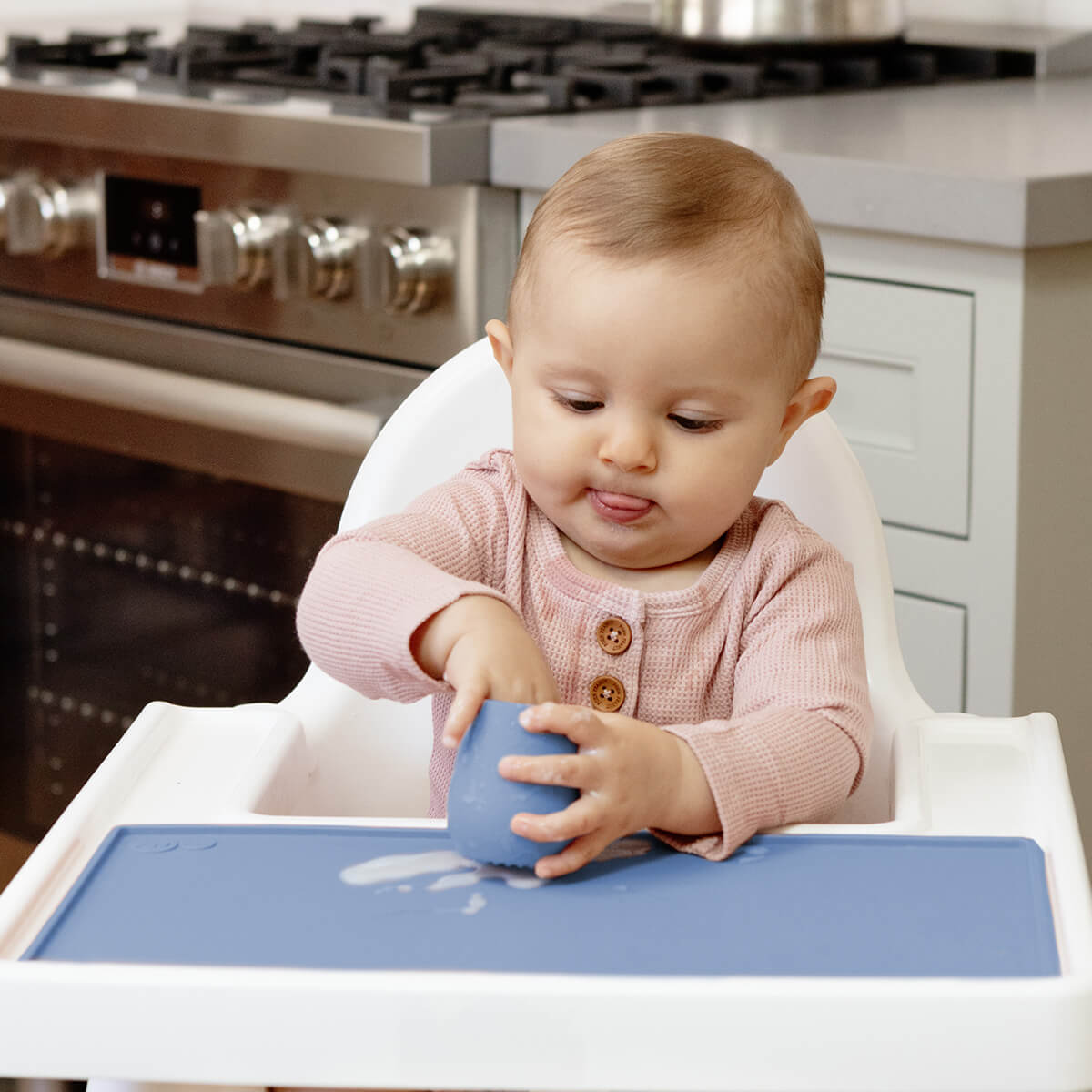 The Tiny Placemat in Indigo is a non-slip, silicone placemat that fits on most highchair trays