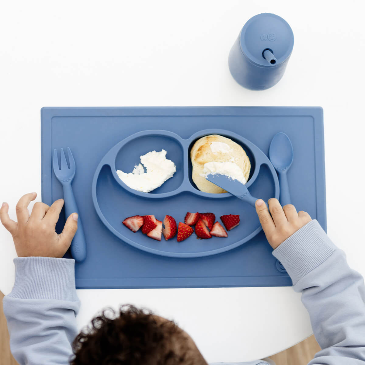 ezpz Happy Feeding Set in Indigo / Silicone, Self-Suctioning Plate, Silicone Cup and Straw, Training Utensils for Toddlers