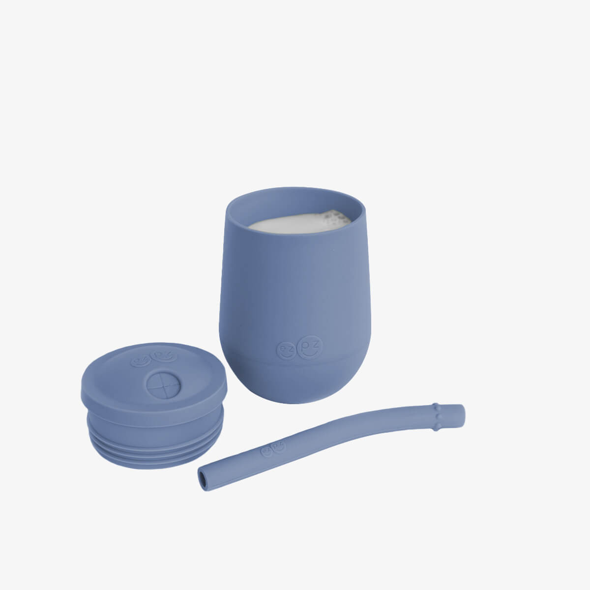 The Mini Cup + Straw in Indigo by ezpz / Silicone Drinking Cup and Straw Training System for Toddlers
