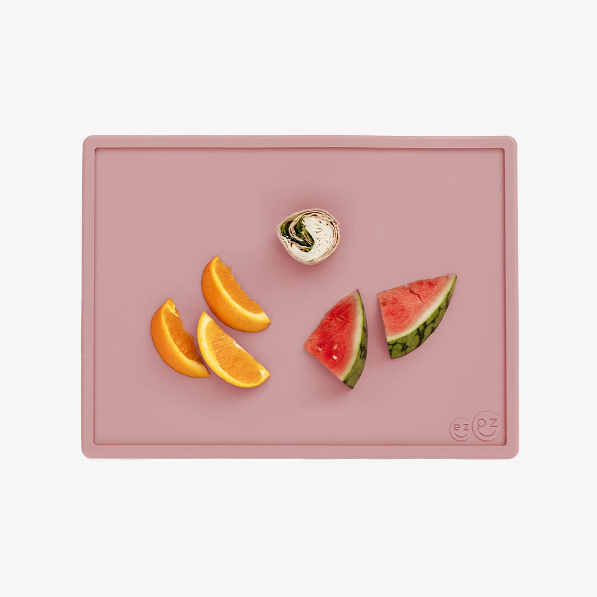 ezpz Mini Placemat in Blush Pink is a silicone placemat for toddlers that grips to the table