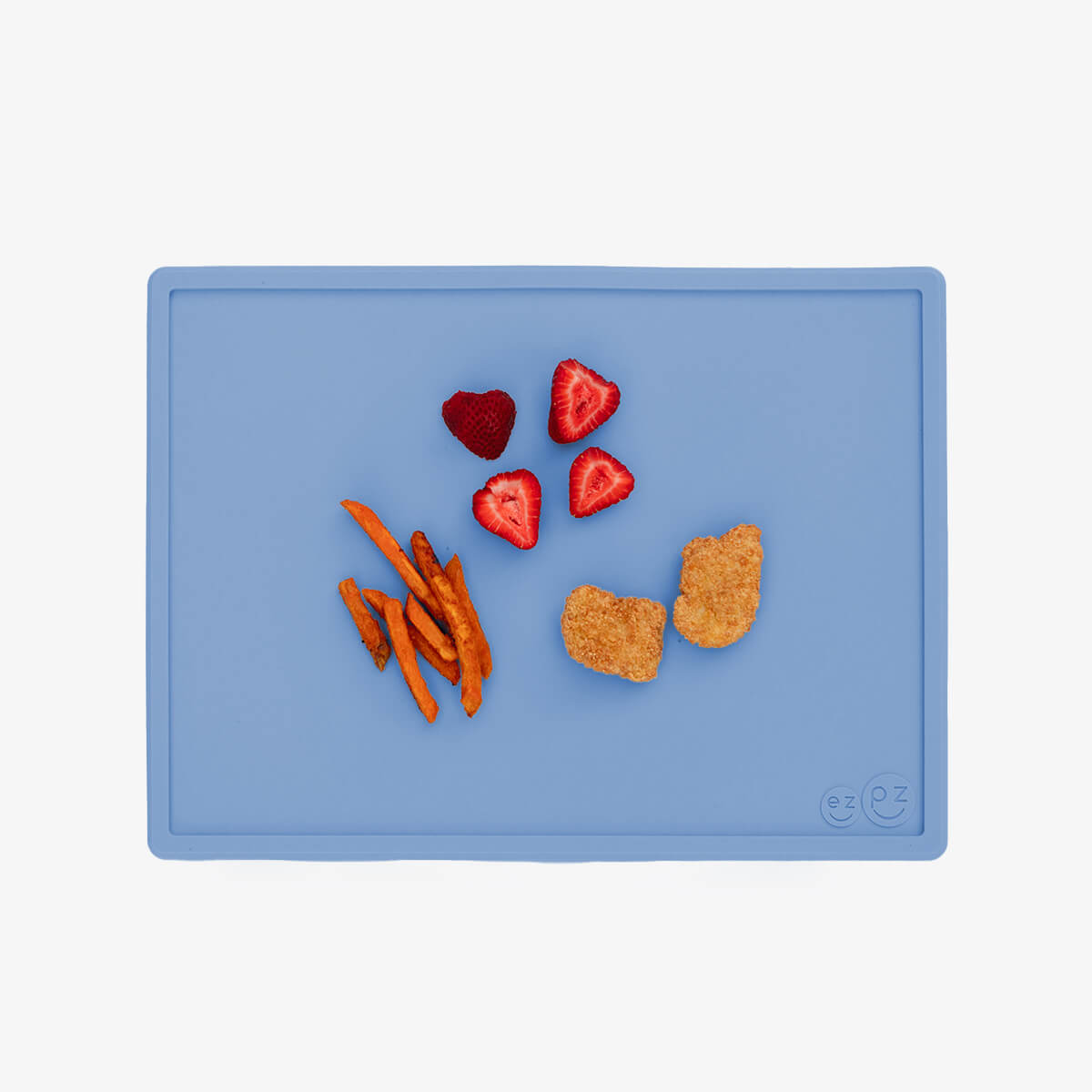 ezpz Mini Placemat in Indigo Blue is a silicone placemat for toddlers that grips to the table