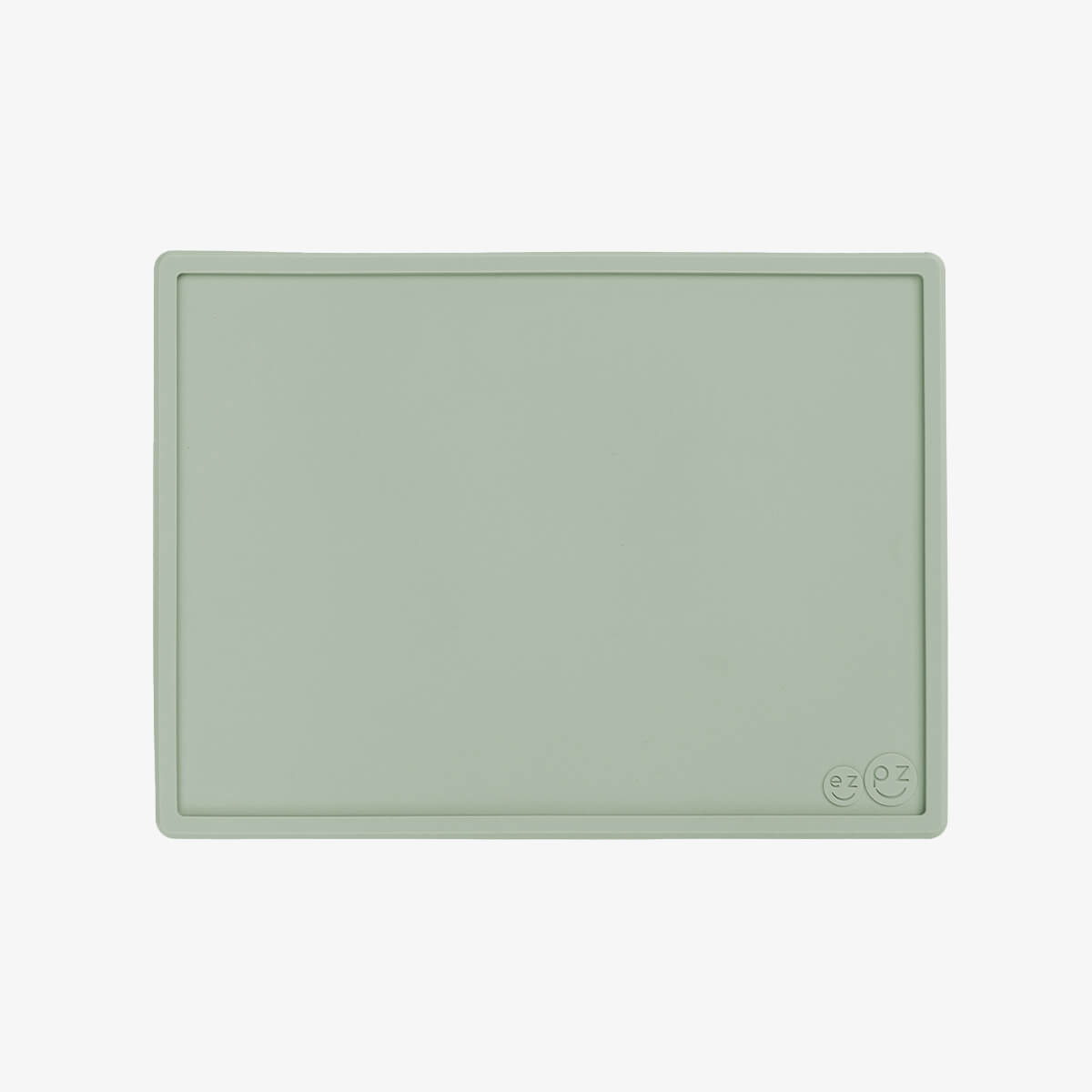 ezpz Mini Placemat in Sage Green is a silicone placemat for toddlers that grips to the table
