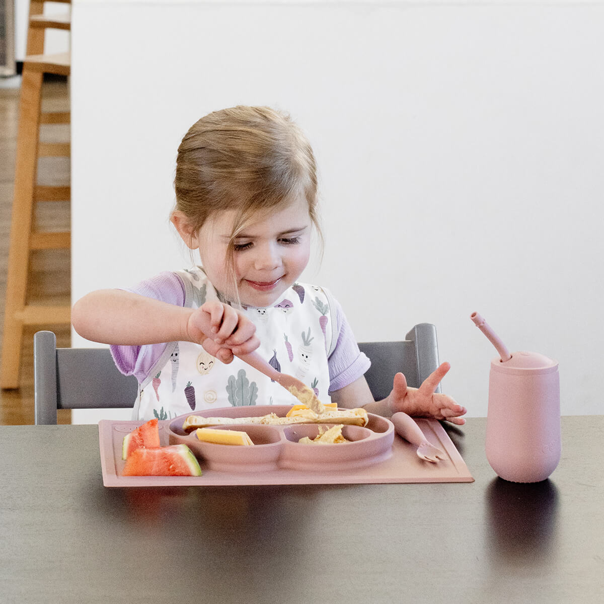 ezpz Happy Feeding Set in Blush / Silicone, Self-Suctioning Plate, Silicone Cup and Straw, Training Utensils for Toddlers