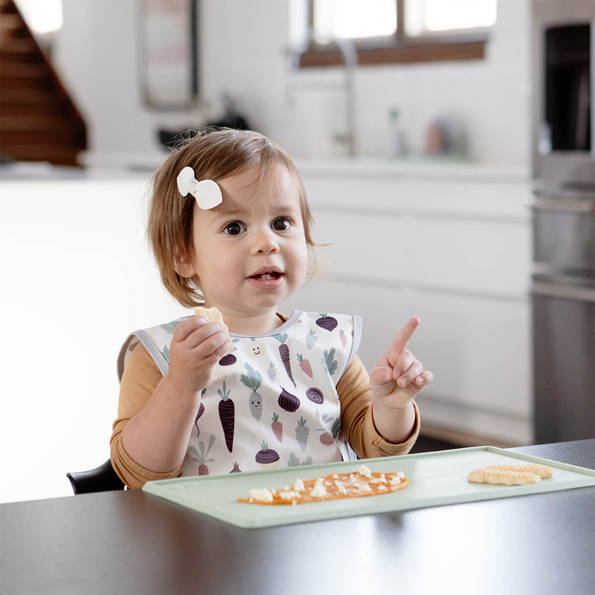 The Tiny Placemat in Sage is a non-slip, silicone placemat that fits on most highchair trays