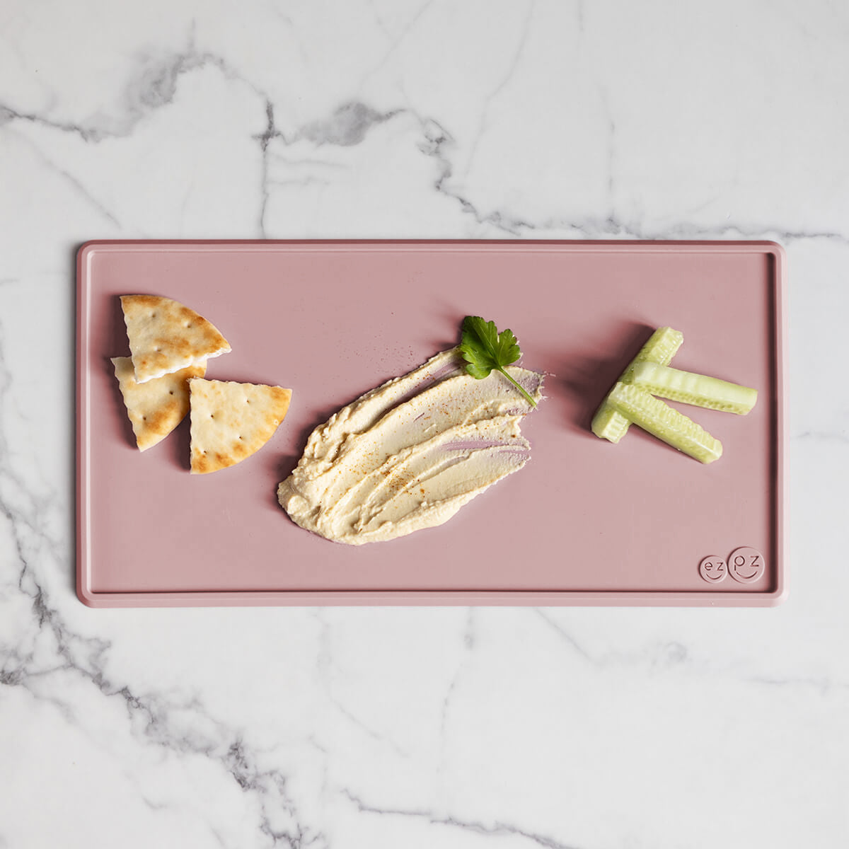 The Tiny Placemat in Blush is a non-slip, silicone placemat that fits on most highchair trays