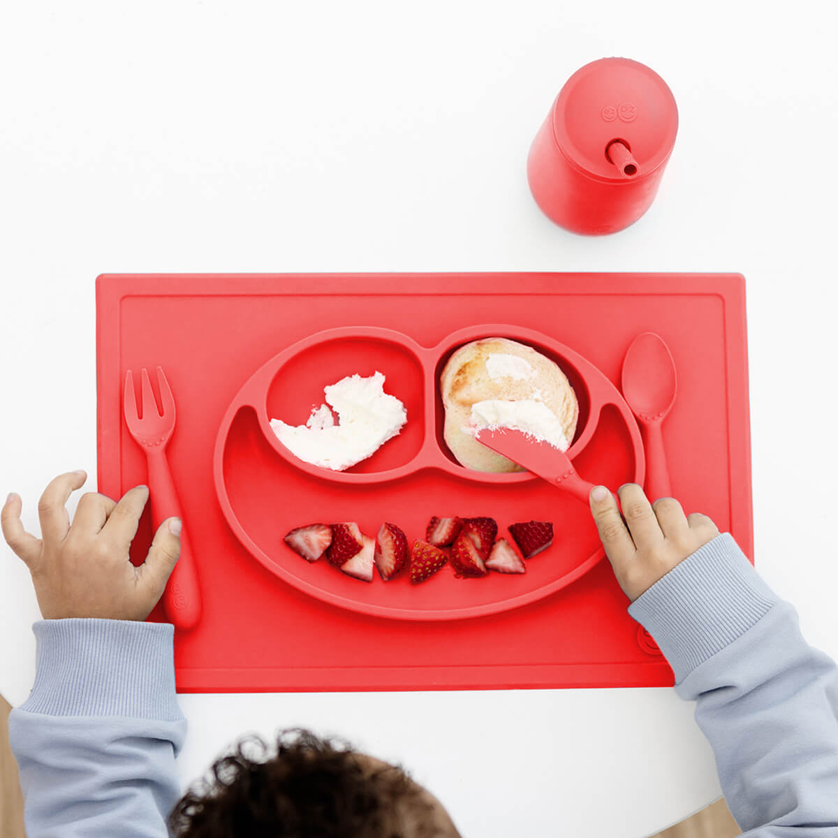 ezpz Happy Feeding Set in Coral / Silicone, Self-Suctioning Plate, Silicone Cup and Straw, Training Utensils for Toddlers