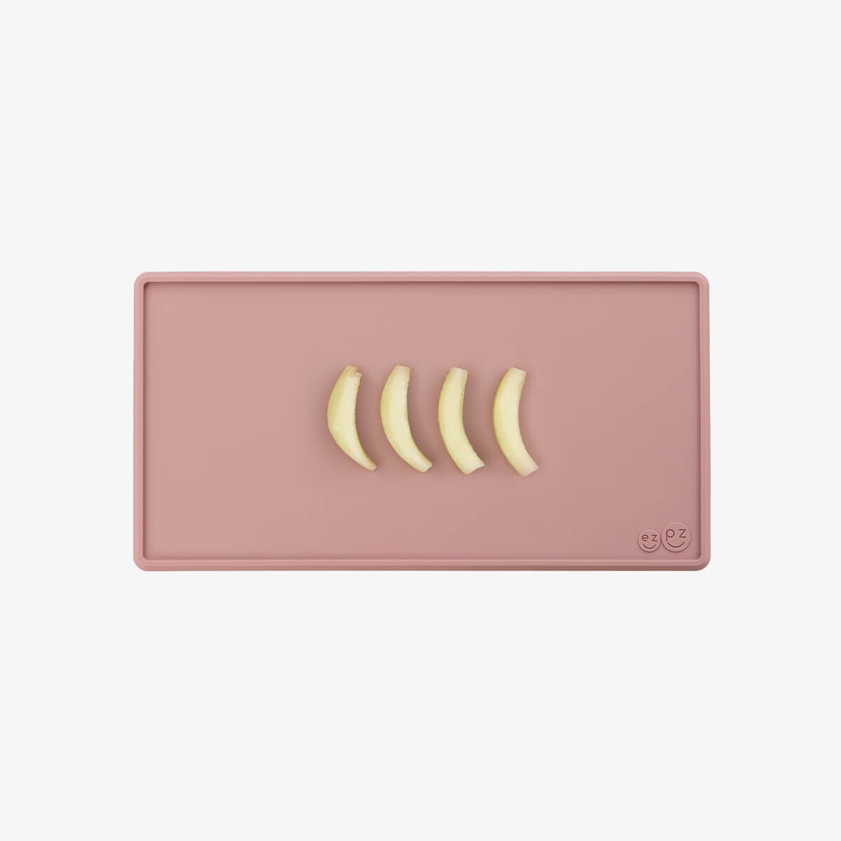The Tiny Placemat in Blush is a non-slip, silicone placemat that fits on most highchair trays #color_blush
