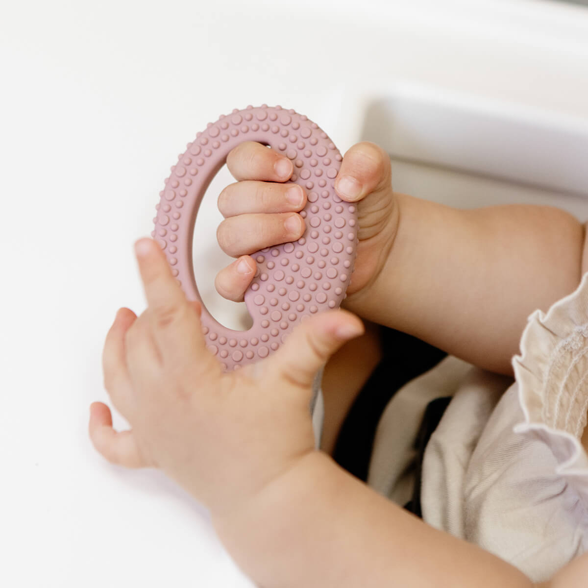 ezpz oral development tools in blush pink / silicone teethers for motor skill development