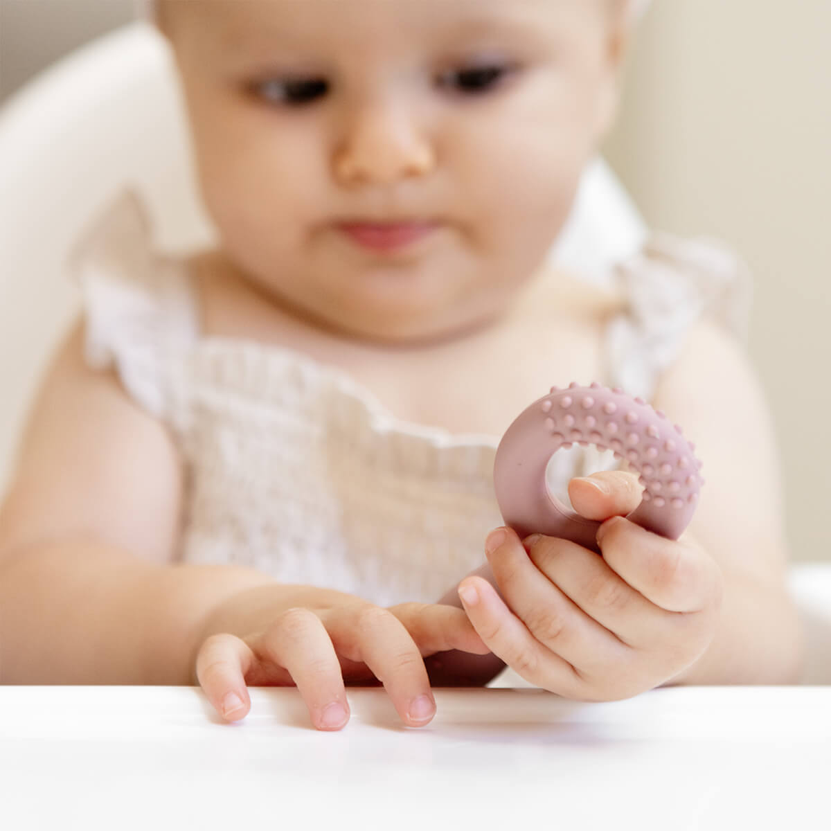 ezpz oral development tools in blush pink / silicone teethers for motor skill development