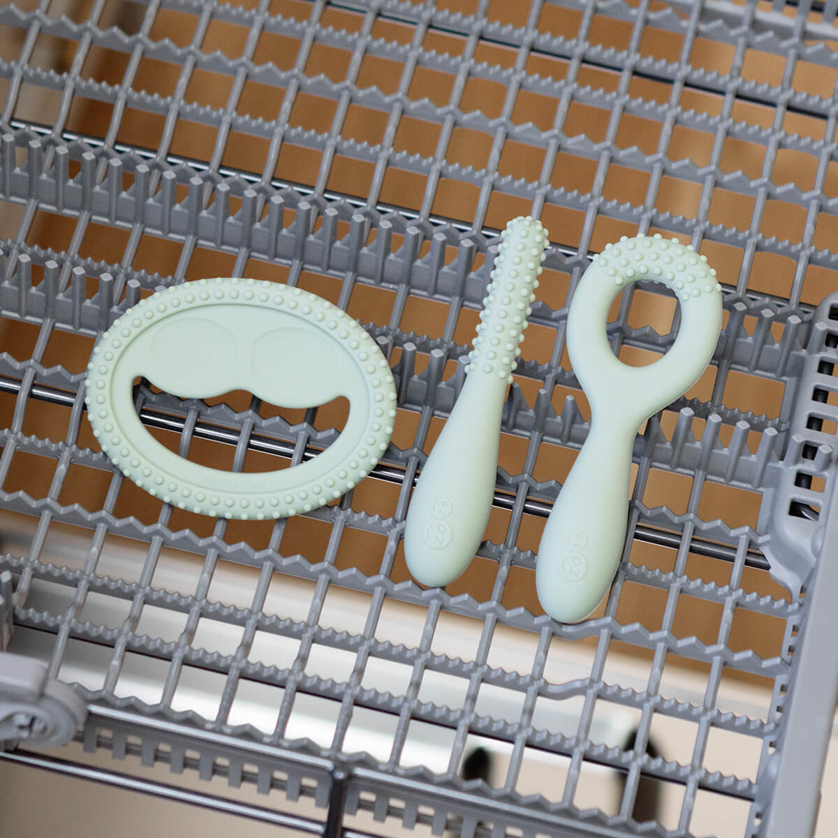 ezpz oral development tools in sage green / silicone teethers for motor skill development