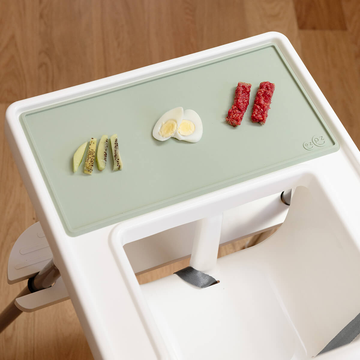 The Tiny Placemat in Sage is a non-slip, silicone placemat that fits on most highchair trays