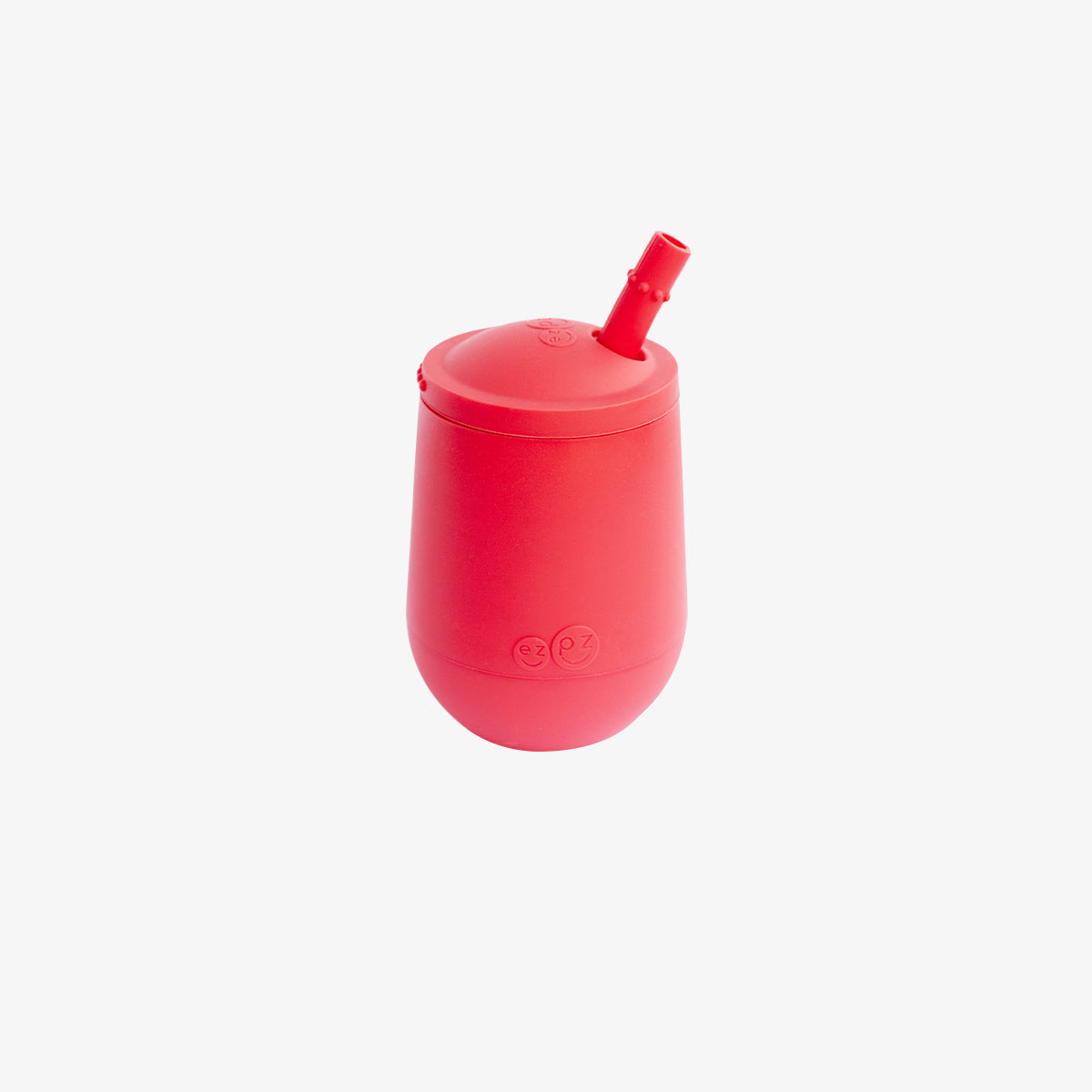The Mini Cup + Straw in Coral by ezpz / Silicone Drinking Cup and Straw Training System for Toddlers