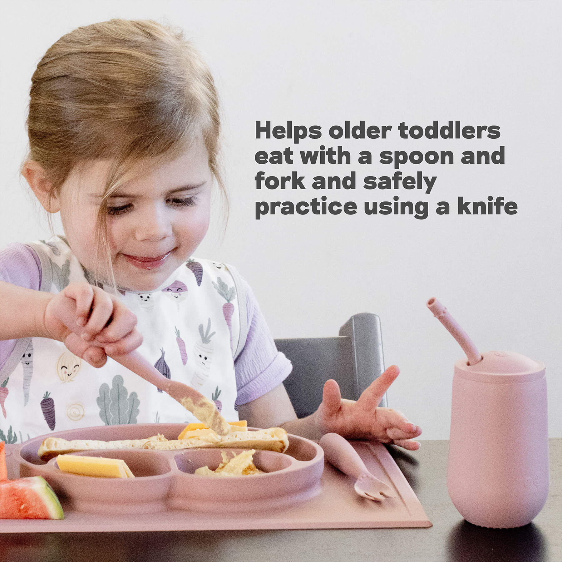 ezpz Developmental Utensil Set helps older toddlers eat with a spoon and fork and safely practice using a knife