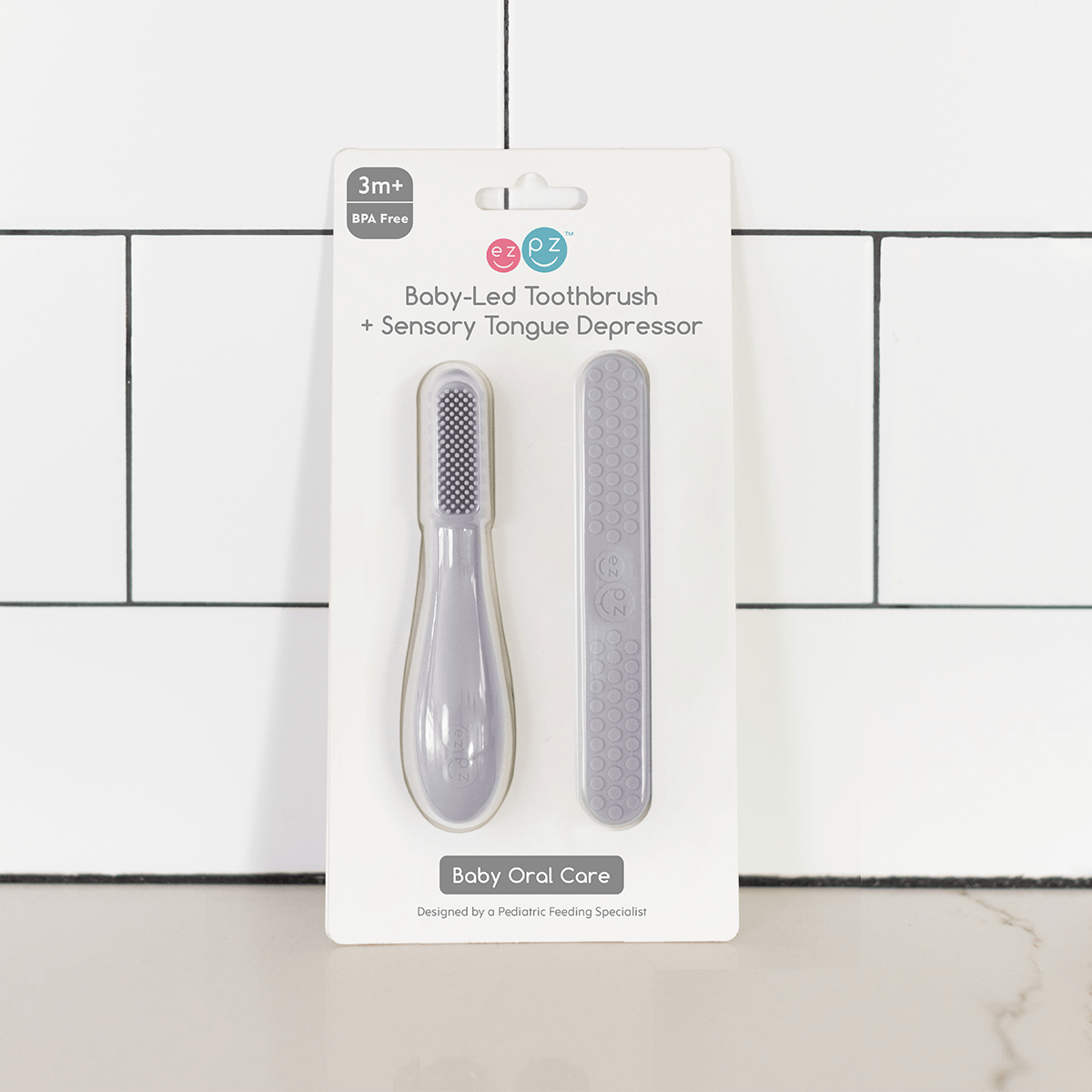 ezpz baby led toothbrush and sensory tongue depressor in pewter gray