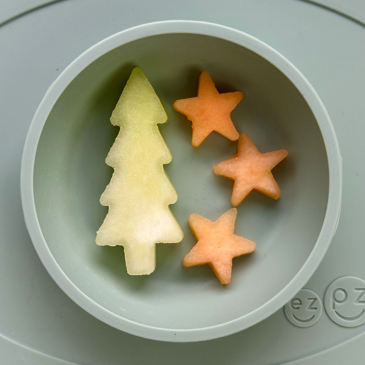 ezpz Baby-Led Weaning Festive Food Cutters to cut baby food into star and tree shapes Christmas-themed