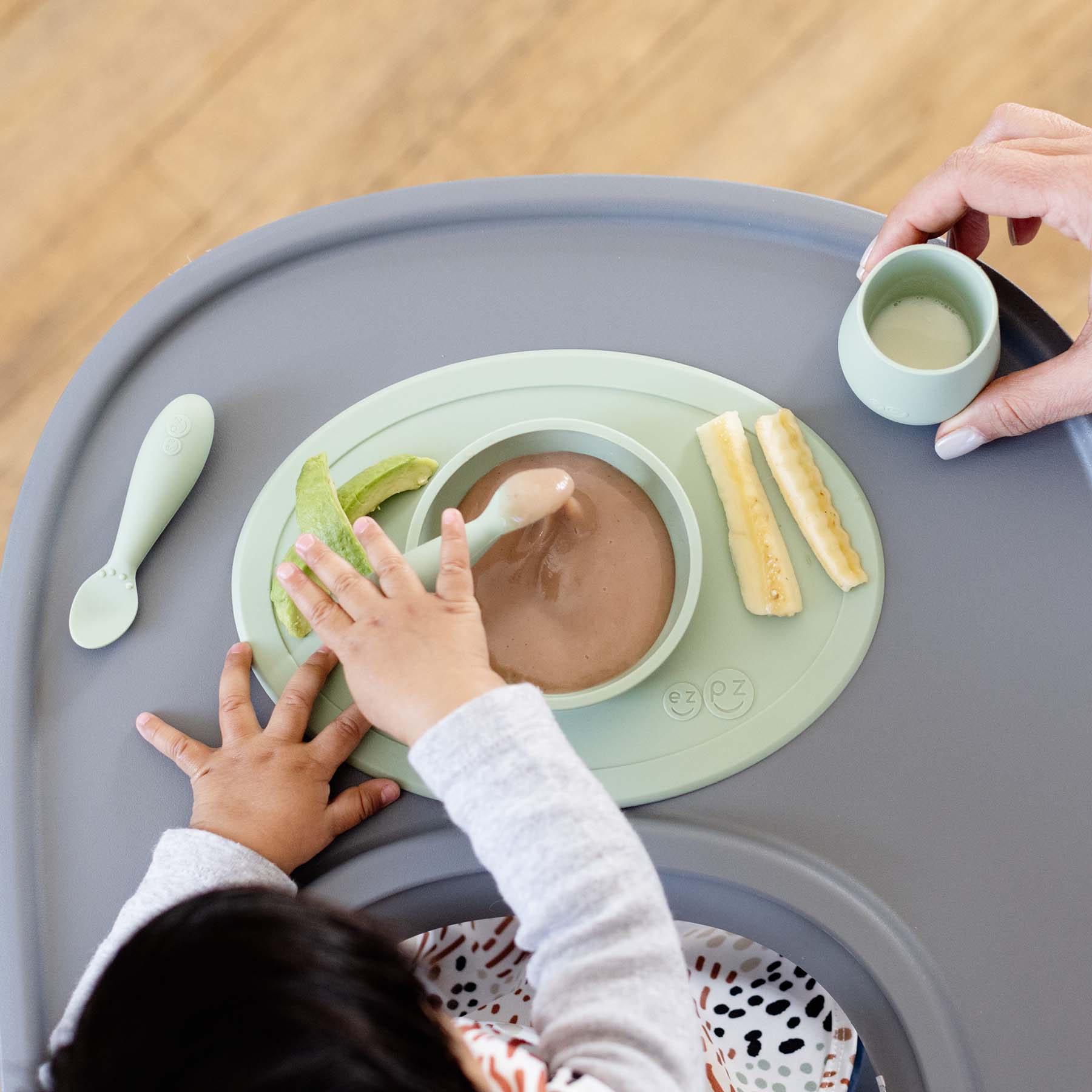 ezpz First Foods Set includes a silicone bowl, cup, and spoons for baby-led weaning and eating skill development for babies