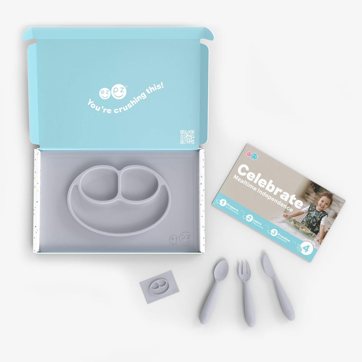 ezpz Kit 4 - Celebrate Mealtime Independence in Pewter Gray includes the Happy Mat, Happy Utensils, and Micro Mat 