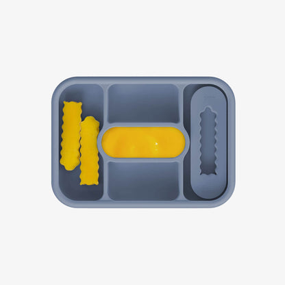 ezpz travel box in indigo blue is an all-in-one feeding + storage system that helps families pack, transport, and serve baby’s meals when away from home 