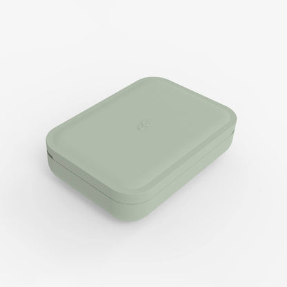 ezpz travel box in sage green is an all-in-one feeding + storage system that helps families pack, transport, and serve baby’s meals when away from home 