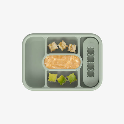 ezpz travel box in sage green is an all-in-one feeding + storage system that helps families pack, transport, and serve baby’s meals when away from home 
