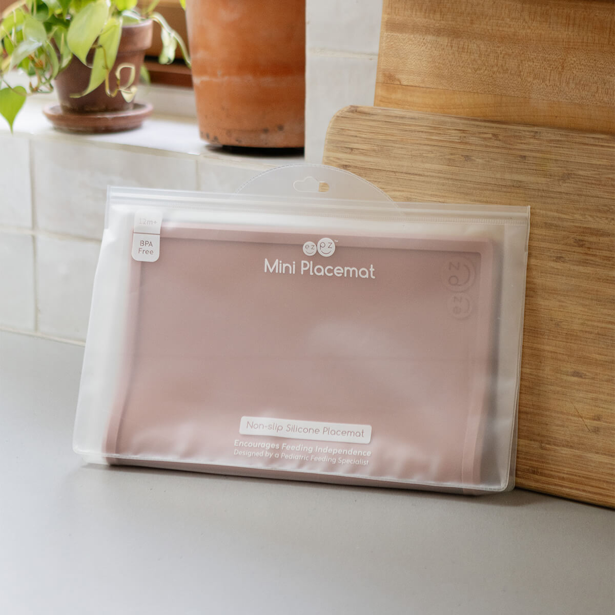 ezpz Mini Placemat in Blush Pink is a silicone placemat for toddlers that grips to the table