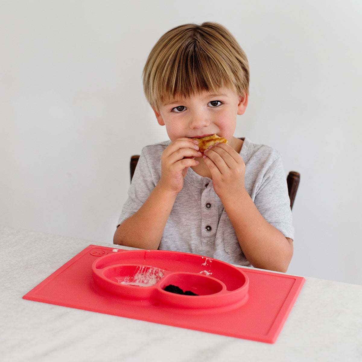 Happy Mat in Coral by ezpz / The Original All-In-One Silicone Plates & Placemats that Stick to the Table